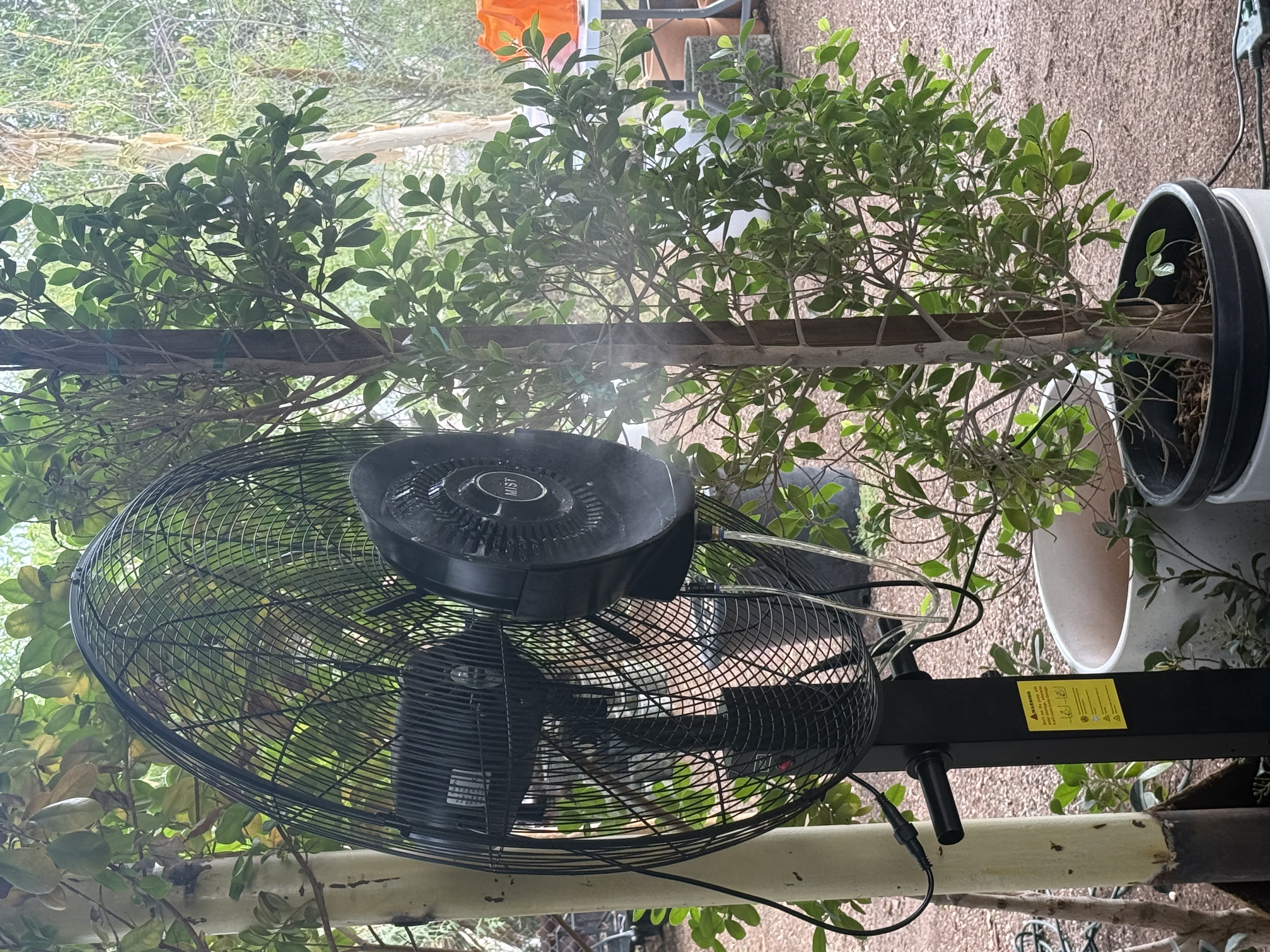 Misting fan in garden patio setting
