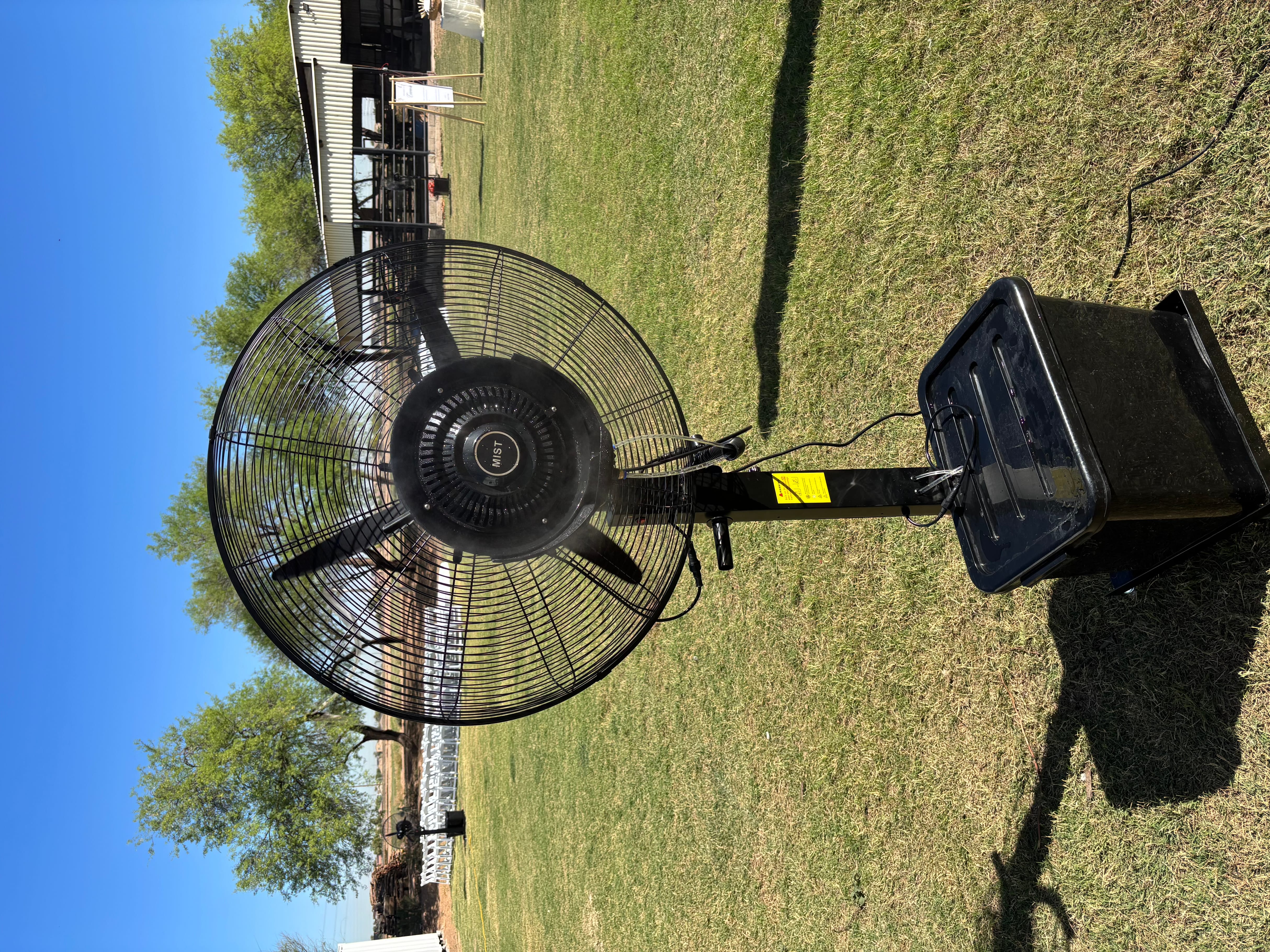 Misting fan set up on grass lawn