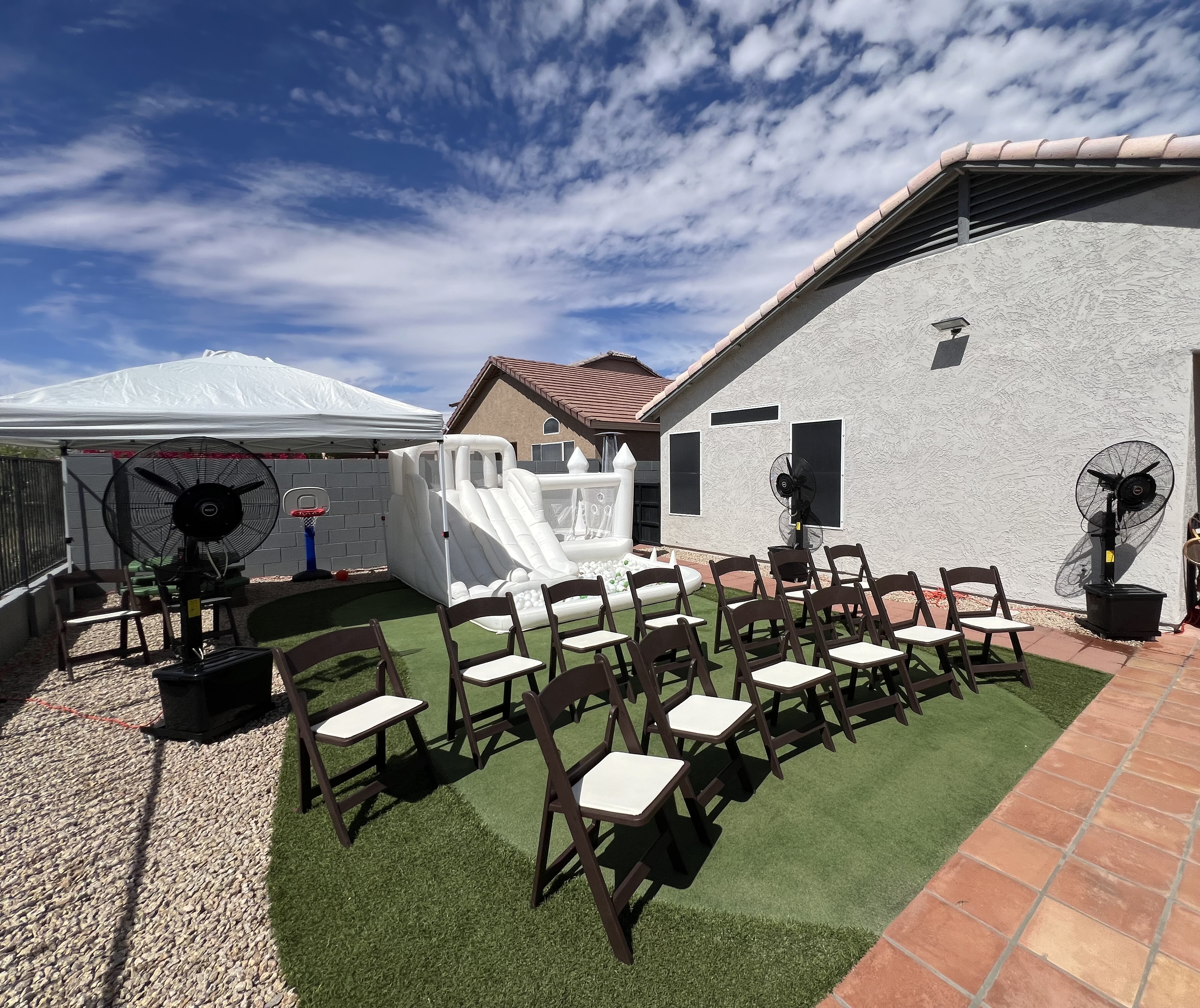 Outdoor party with tent and bounce house